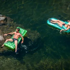 2 women in green and black bikini lying on green inflatable float on water during daytime related to Discovering the Best Deals on Inflatable Beds at Costco