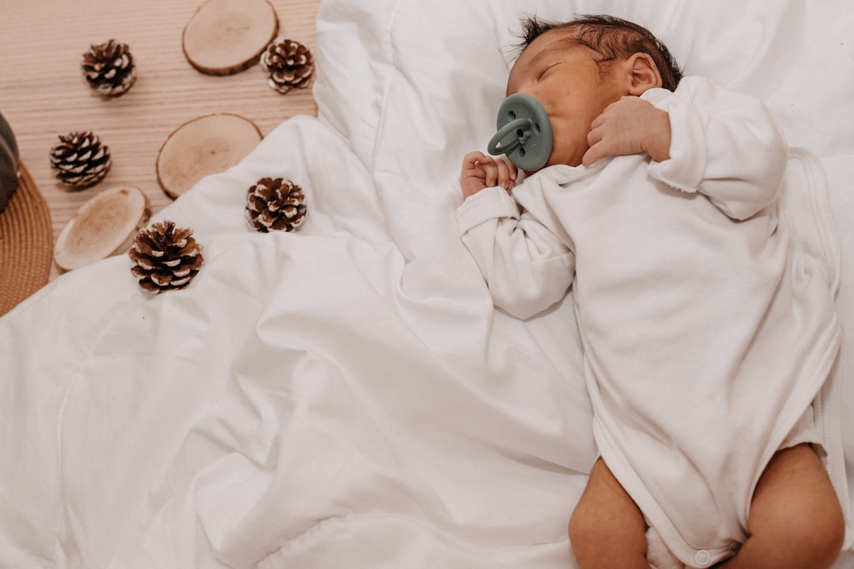 a baby lying on a bed related to 7 Essentials for Creating a Dreamy Gender Neutral Baby Bedding Set