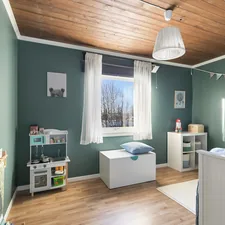 A baby's room with green walls and a wooden ceiling related to Valance for Boys Room