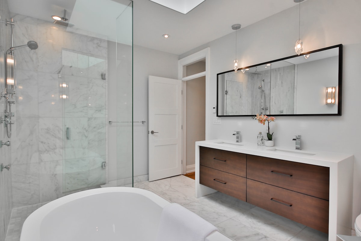a bathroom with a large white bathtub next to a walk in shower related to Transform Your Bathroom with Stylish Shower Curtains