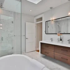 a bathroom with a large white bathtub next to a walk in shower related to Transform Your Bathroom with Stylish Shower Curtains