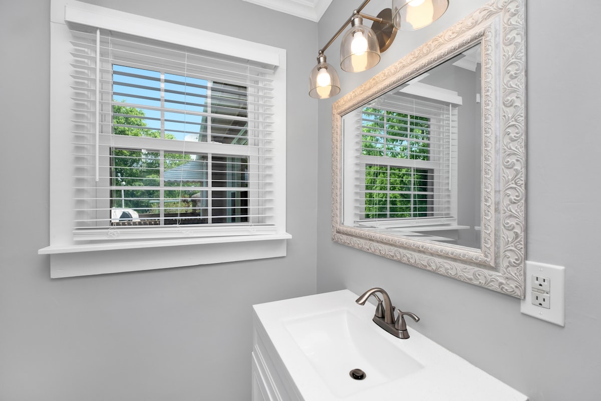 a bathroom with a sink and a window related to Elegant Solutions for Small Bathroom Window Valances