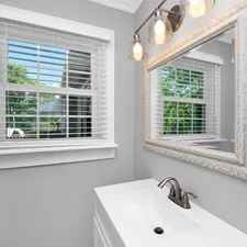 a bathroom with a sink and a window related to Elegant Solutions for Small Bathroom Window Valances