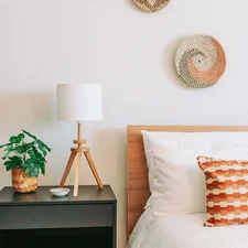 a bed room with a neatly made bed and a night stand related to Revamp Your Bedroom with Pottery Barn's Exciting Bedding Sale