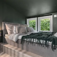 A bed sitting in a bedroom next to a window related to Cozying Up in a Small Space: Tiny House Bed Ideas