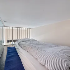 A bed sitting in a bedroom next to a window related to The Ultimate Twin Loft Bed with Slide Guide