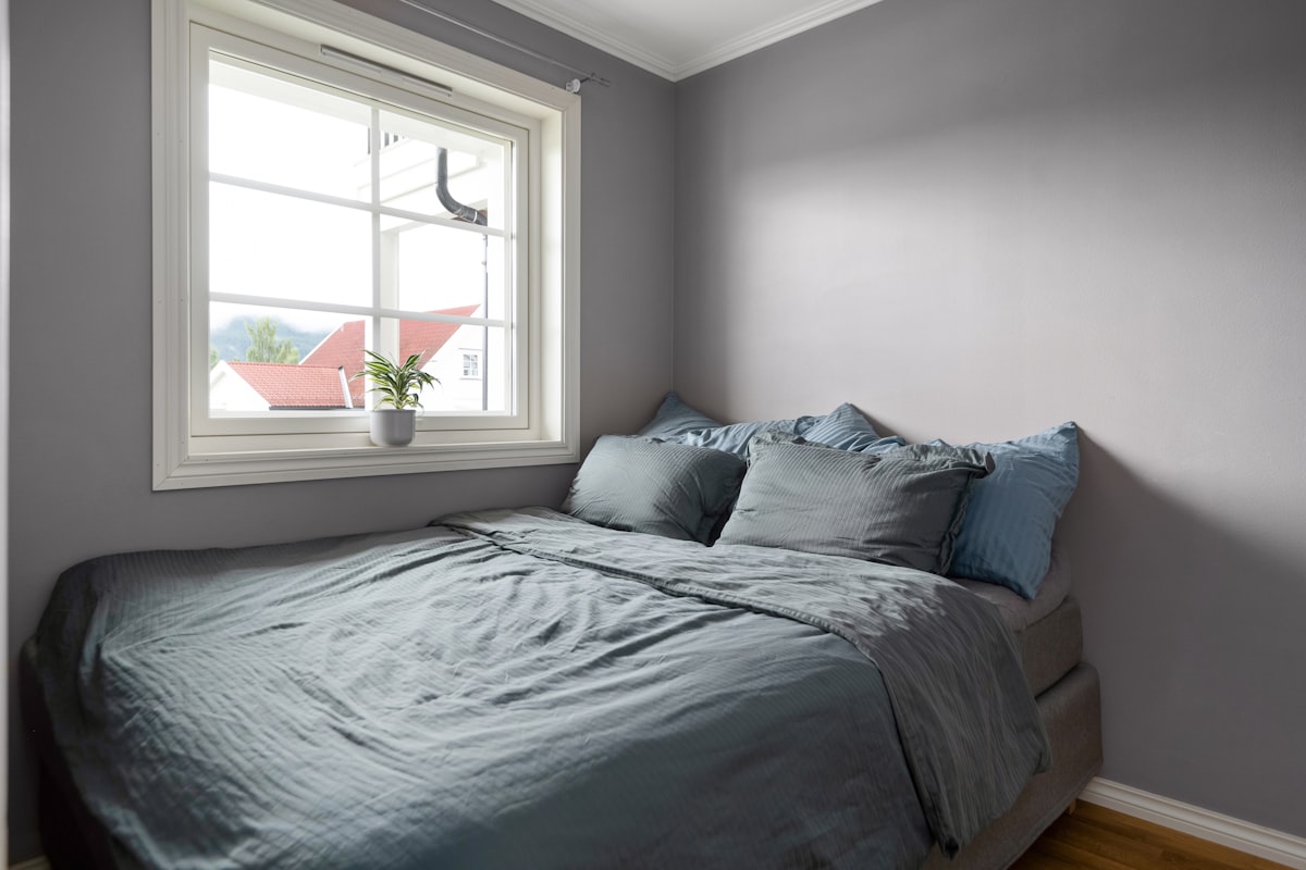 A bed sitting under a window in a bedroom related to Revamp Your Truck's Bed with a Durable Bed Liner Paint Job