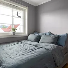 A bed sitting under a window in a bedroom related to Revamp Your Truck's Bed with a Durable Bed Liner Paint Job