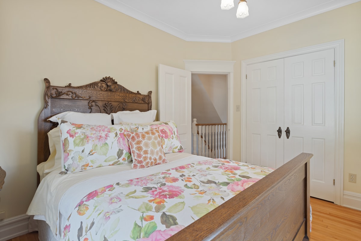 a bed with a floral comforter and pillows related to Bed and Breakfast in Alexandria, VA: Unforgettable Accommodations