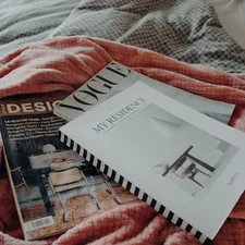 a bed with a red blanket and a book on top of it related to Transform Your Space with the Perfect Day Bed Bedding