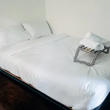 a bed with white sheets and pillows in a room related to Mastering the Art of Sleep: Everything You Need to Know About Full Size Beds