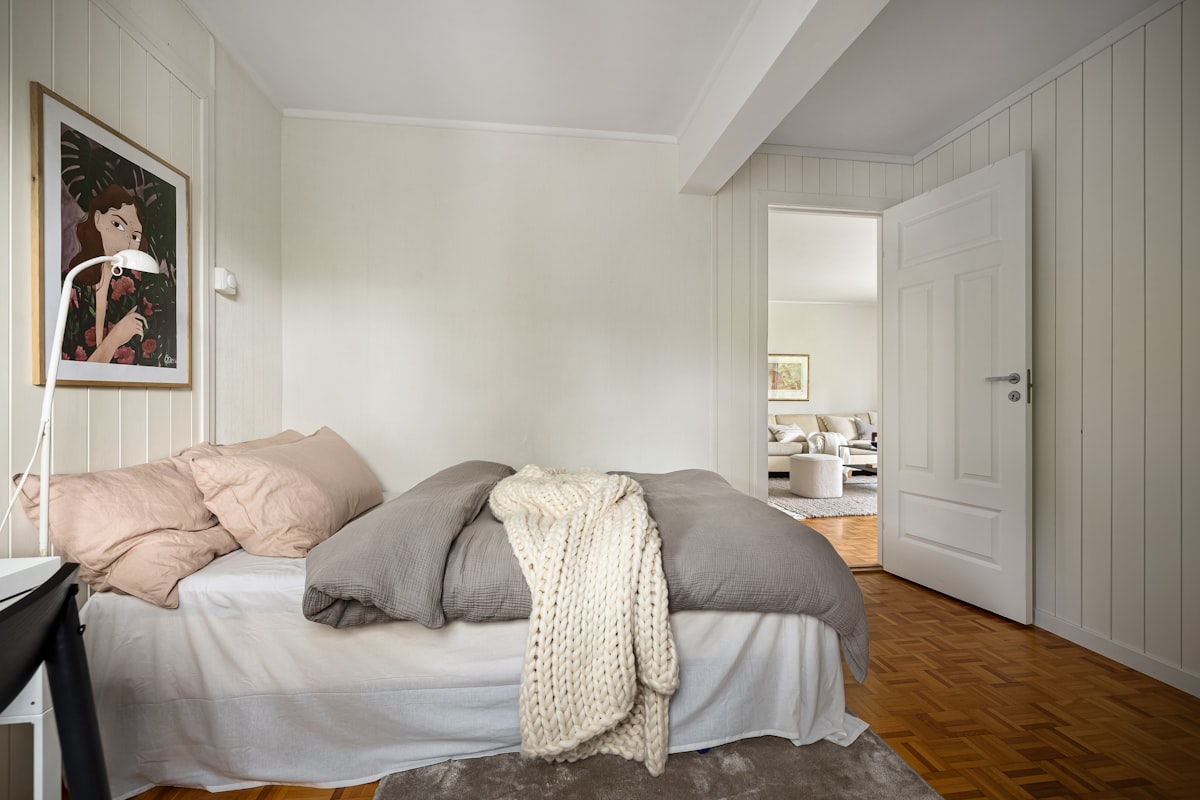 A bedroom with a bed and a desk related to Swoon-Worthy Shabby Chic Beds: A Guide to Romantic Bedroom Elegance