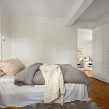 A bedroom with a bed and a desk related to Swoon-Worthy Shabby Chic Beds: A Guide to Romantic Bedroom Elegance
