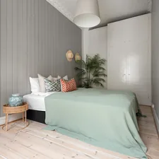 A bedroom with a bed and a painting on the wall related to Stylish Combinations for Your Bedroom