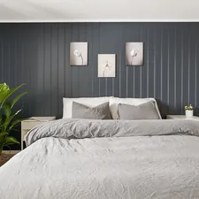 A bedroom with a bed and a plant in the corner related to Stylish Bedding Ideas for a Modern Bedroom