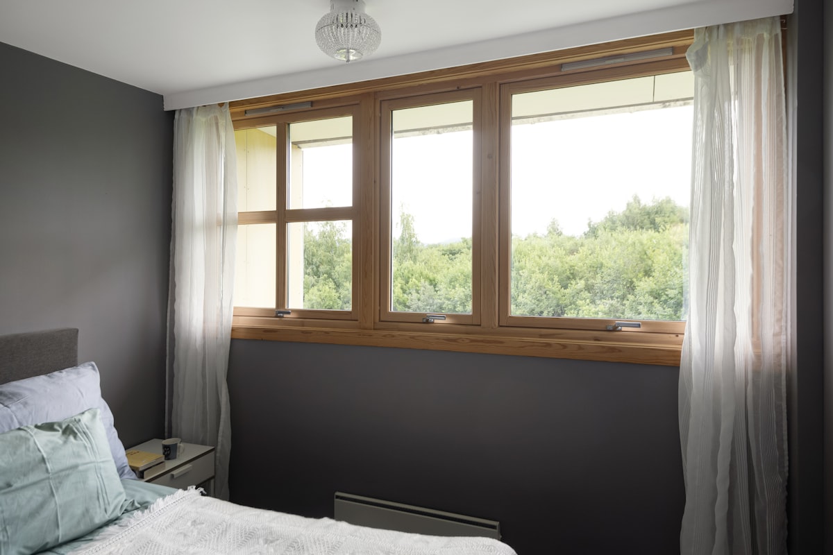 A bedroom with a bed and a window related to Transforming Your Windows with Majestic Victorian Valance Curtains