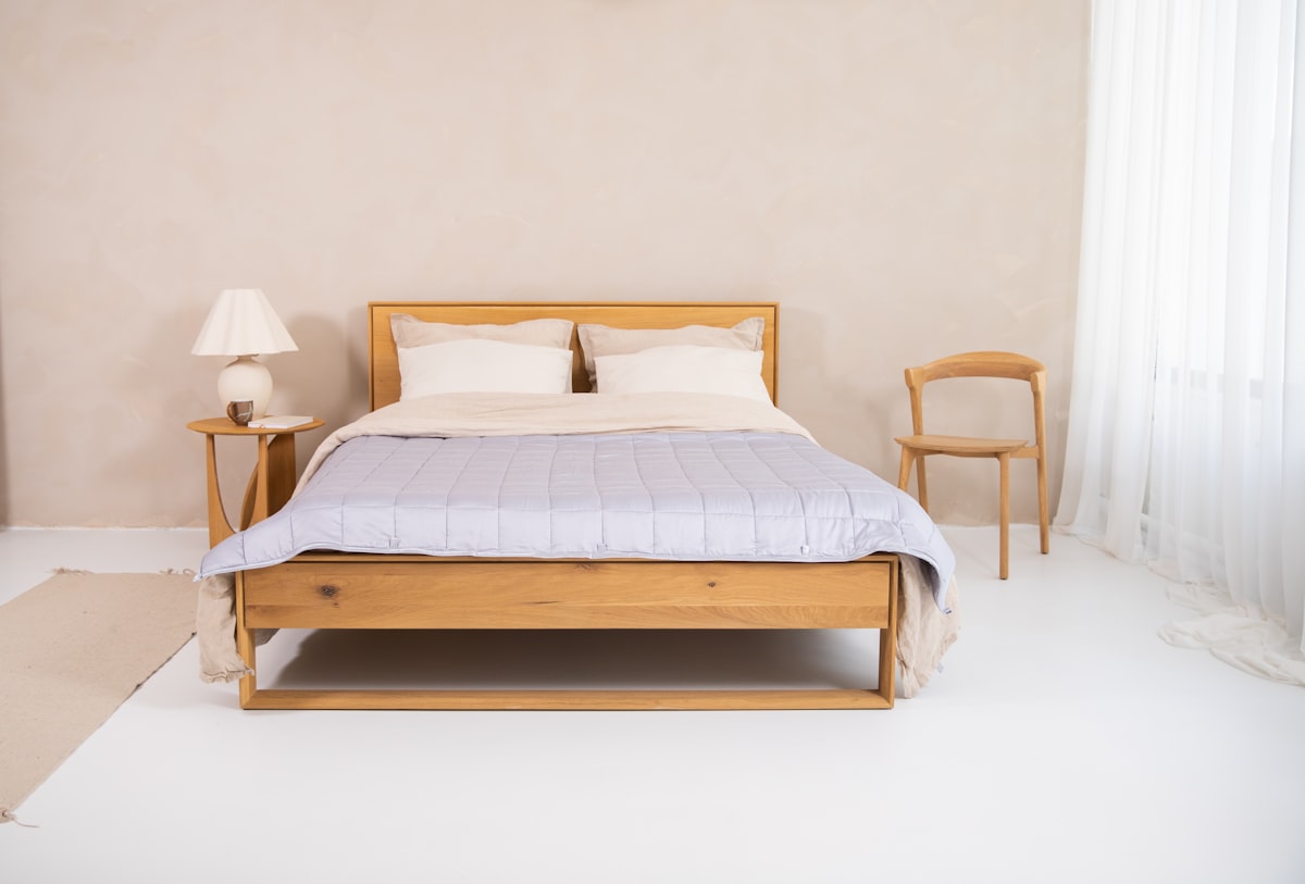 a bedroom with a bed and two chairs related to Quilt & Coverlet: A Cozy Guide