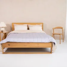 a bedroom with a bed and two chairs related to Quilt & Coverlet: A Cozy Guide