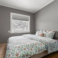 A bedroom with a bed, dresser and window related to Cozy Up with Frozen Twin Bedding: A Magical Slumber Experience