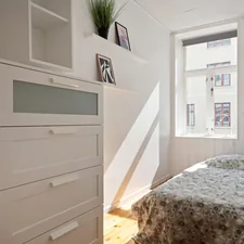 A bedroom with a bed, dresser, and window related to Maximizing Space with Twin Loft Bed with Storage Solutions