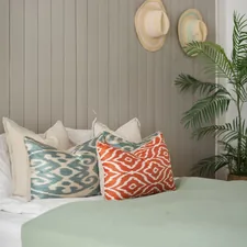 A bedroom with a bed, pillows and a potted plant related to Mint to Be: Refreshing Your Bedroom with Mint and Gray Bedding