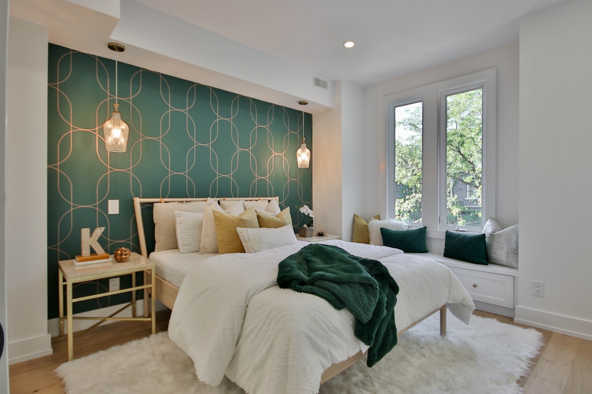 a bedroom with a green wall and a white bed related to Transform Your Bedroom with the Chic and Cozy 100 Cotton Coverlet