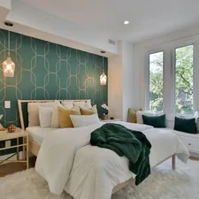 a bedroom with a green wall and a white bed related to Transform Your Bedroom with the Chic and Cozy 100 Cotton Coverlet