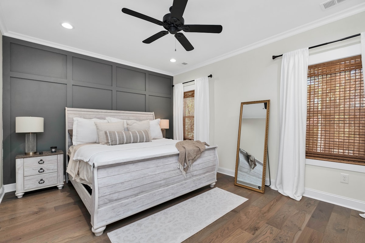 a bedroom with a large bed and a ceiling fan related to Elevate Your Bedroom with a Queen Quilted Coverlet