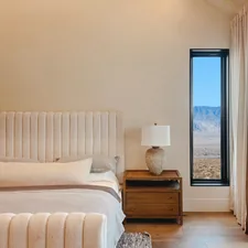 a bedroom with a large bed and a large window related to The Ultimate Sleeping Experience: California King Bed
