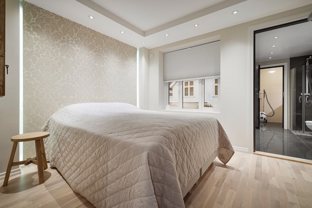 A bedroom with a large bed and a sliding glass door related to Bed Bath and Beyond Application