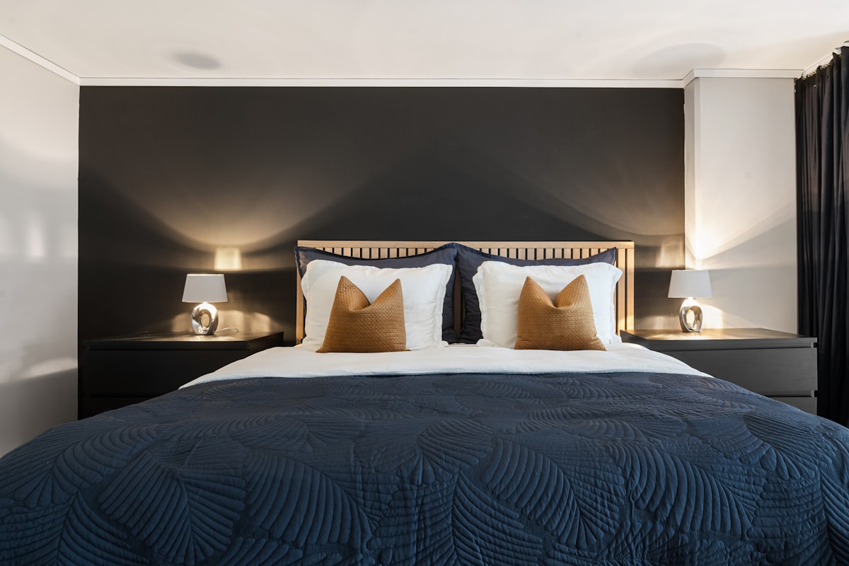 A bedroom with a large bed and two night stands related to The Epitome of Elegance: Unveiling Black Luxury Bedding