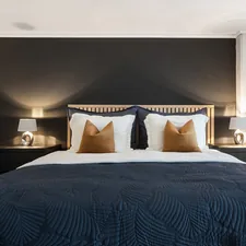 A bedroom with a large bed and two night stands related to The Epitome of Elegance: Unveiling Black Luxury Bedding