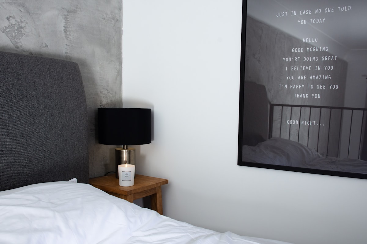 a bedroom with a picture hanging on the wall related to The Ultimate Guide to Grey Bed Frames