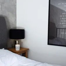 a bedroom with a picture hanging on the wall related to The Ultimate Guide to Grey Bed Frames