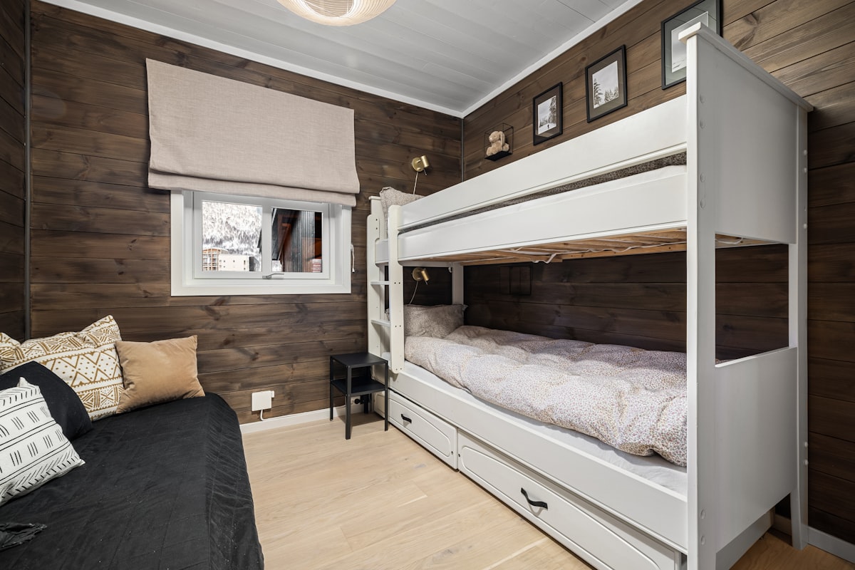 A bedroom with bunk beds and a couch related to Sleep Smart: A Guide to Finding the Best Cheap Bunk Beds