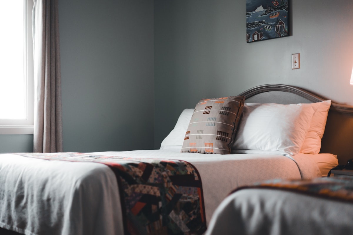 a bedroom with two beds and a window related to Cozy and Stylish: Twin Bed Coverlets to Elevate Your Space