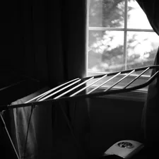 A black and white photo of a bed and a window related to Timeless Elegance: Black and White Crib Bedding for Your Little One