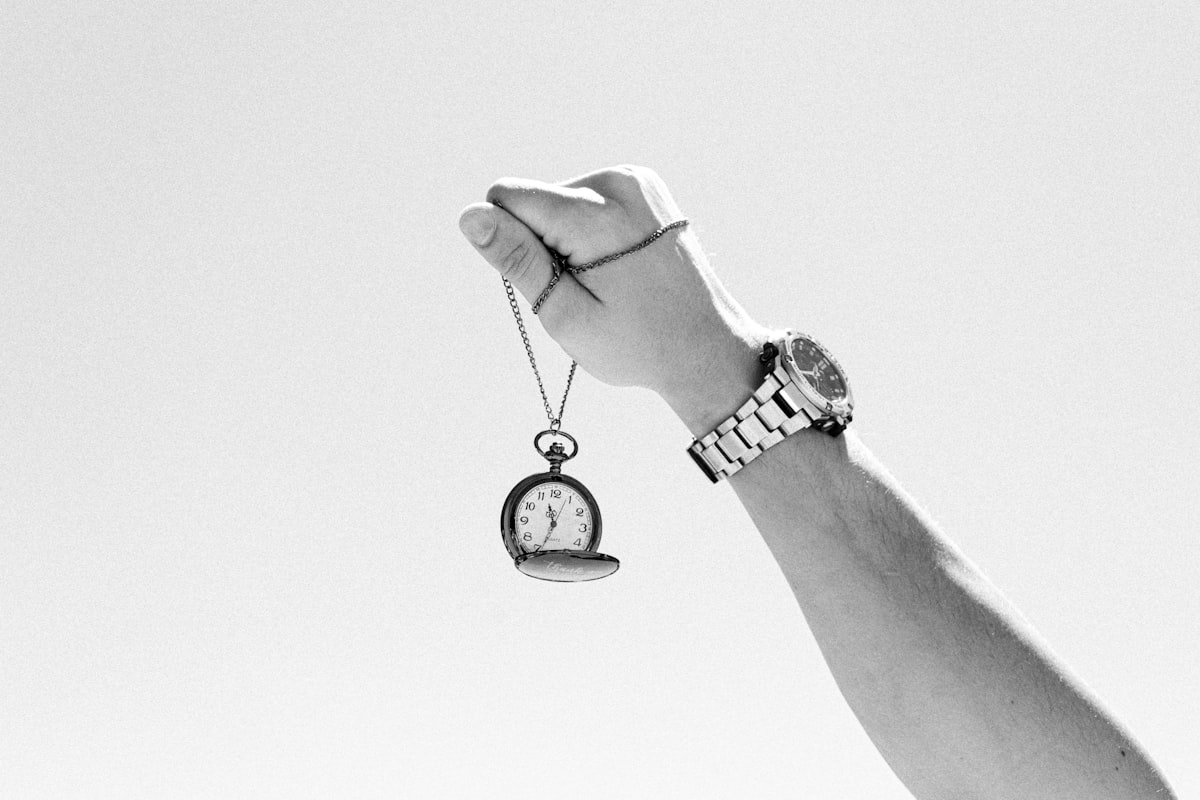 a black and white photo of a person holding a watch related to Exploring the Timeless Charm of Ethan Allen Sleigh Beds