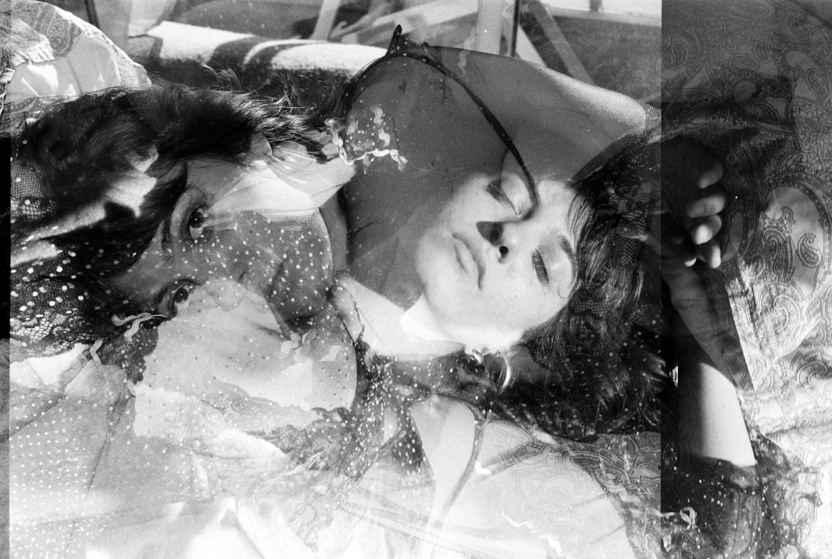 a black and white photo of a woman laying on a bed related to Sweet Dreams in Style: The KidKraft Princess Toddler Bed