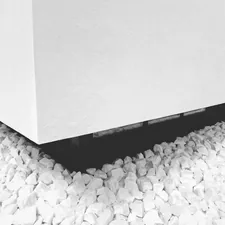 a black and white photo of rocks under a building related to Sleek and Smart: The Best Under Bed Shoe Storage Solutions