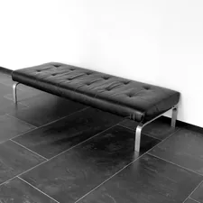 A black leather bench on a tiled floor. related to Stunning Modern Entryway Benches to Welcome Your Guests