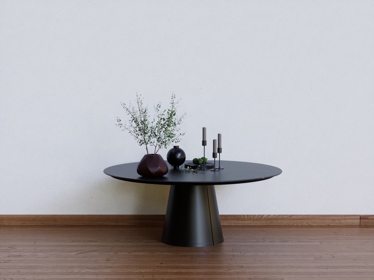 a black table with two vases on top of it related to Round Entryway Tables: Embrace Elegance and Functionality