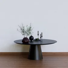 a black table with two vases on top of it related to Round Entryway Tables: Embrace Elegance and Functionality