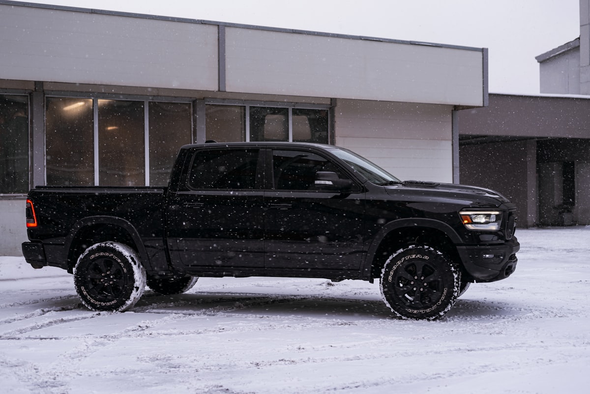 a black truck parked in front of a building related to Find Your Perfect Ride: Dodge Ram Truck Bed for Sale