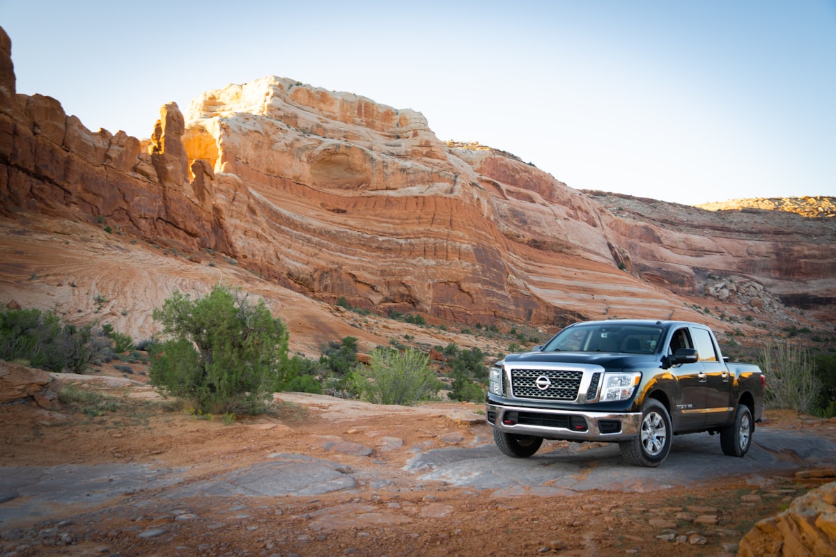 a black truck parked in front of a mountain related to Optimizing Cargo Space: Unveiling the Nissan Frontier Bed Dimensions