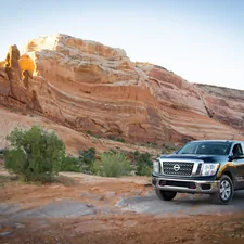 a black truck parked in front of a mountain related to Optimizing Cargo Space: Unveiling the Nissan Frontier Bed Dimensions