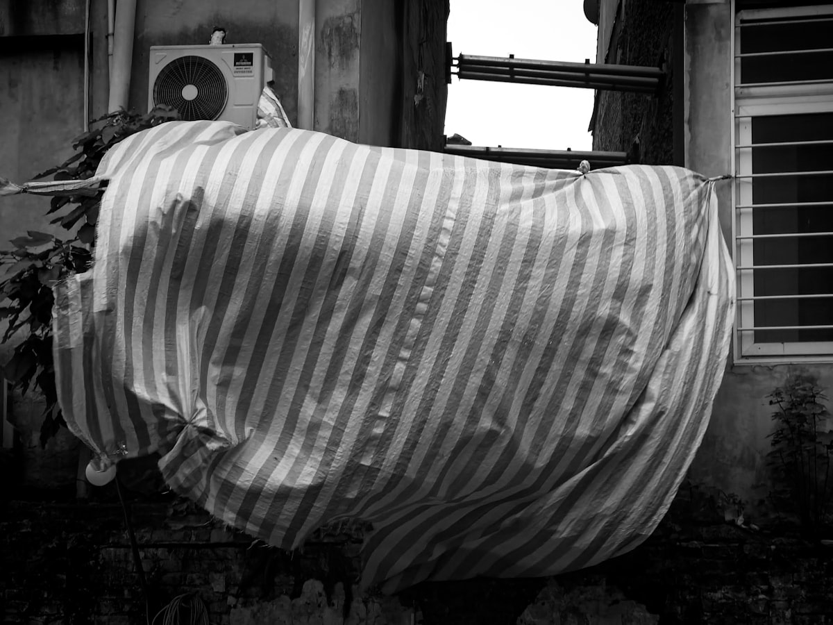 a blanket is draped over a window sill related to Transform Your Bedroom with a Striped Bed Skirt
