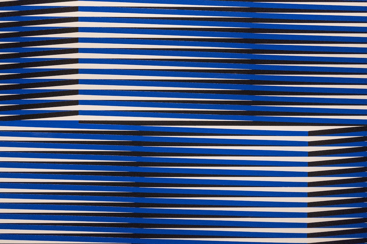 A blue and white abstract background with a diagonal design related to Blue and White Striped Valance