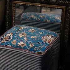 A blue ottoman sitting in front of a mirror related to Choosing the Perfect End of Bed Ottoman for Style and Functionality