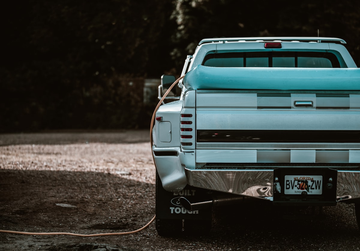 a blue pick up truck parked in a parking lot related to Choosing the Perfect Bed Cover for Your Truck: A Comprehensive Guide